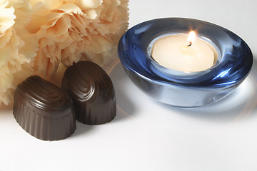 Image showing chocolates and carnation with a candle