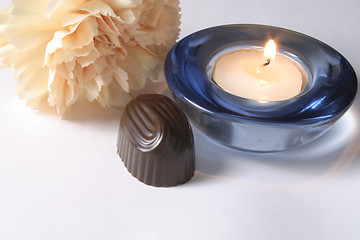 Image showing chocolate and carnation with a candle