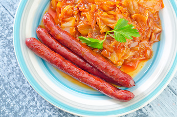 Image showing sausages with fried cabbage