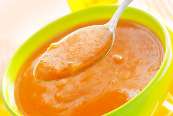 Image showing Fresh soup from pumpkin in the green bowl