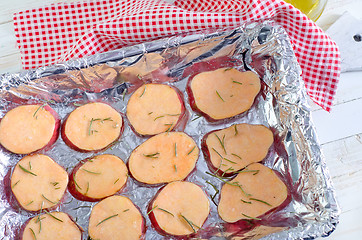 Image showing sweet potato with rosemary on the foil