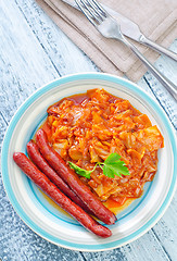 Image showing sausages with fried cabbage