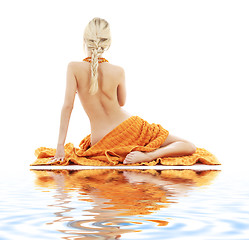 Image showing beautiful lady with orange towels on white sand