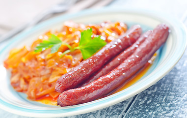 Image showing sausages with fried cabbage