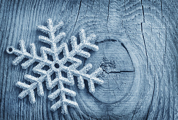 Image showing Silver snowflakes on the wooden background