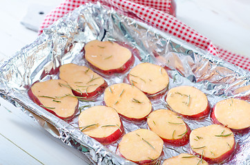 Image showing sweet potato with rosemary on the foil