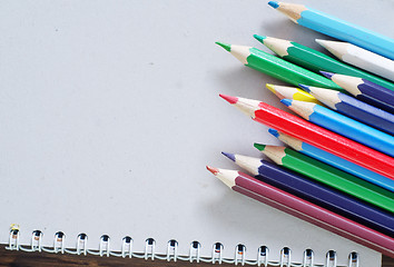 Image showing color pencils and note