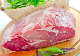 Image showing raw meat and knife on the wooden board