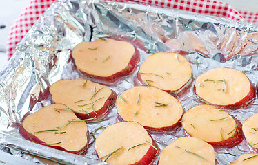 Image showing sweet potato with rosemary on the foil