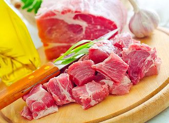 Image showing raw meat and knife on the wooden board