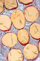 Image showing sweet potato with rosemary on the foil