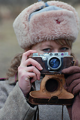 Image showing Girl soldier WWII. With camera