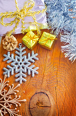 Image showing Cristmas decoration on the wooden background, present and snowfl