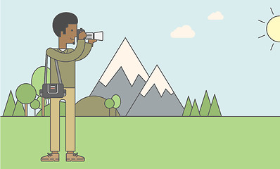 Image showing Photographer taking photo in mountains