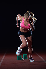 Image showing pixelated design of woman  sprinter leaving starting blocks