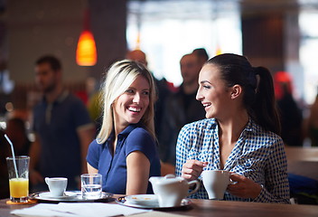 Image showing girls have cup of coffee in restaurant