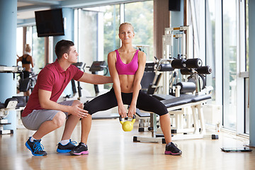 Image showing young sporty woman with trainer exercise weights lifting