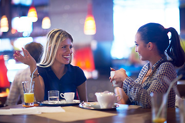 Image showing girls have cup of coffee in restaurant