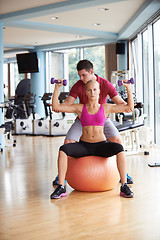 Image showing young sporty woman with trainer exercise weights lifting