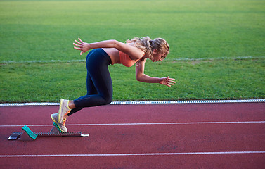 Image showing pixelated design of woman  sprinter leaving starting blocks