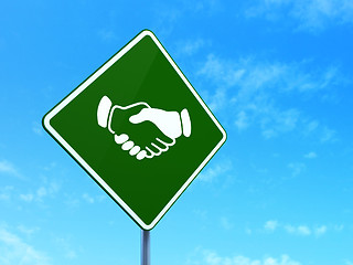 Image showing Finance concept: Handshake on road sign background