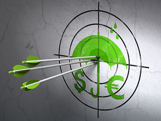 Image showing Protection concept: arrows in Money And Umbrella target on wall background