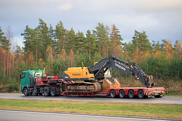 Image showing Volvo FH truck hauls Volvo Hydraulic Crawler Excavator