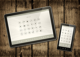 Image showing Smartphone and digital tablet PC with desktop icons on a dark wo