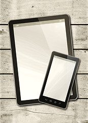 Image showing Smartphone and digital tablet PC on a white wood table