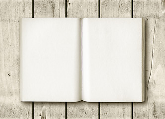 Image showing Open book on a white wood table