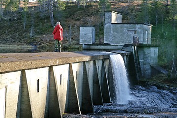 Image showing Man fishing on a dam