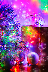 Image showing Christmas tree, balls, box, lit by fairy lights