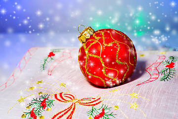 Image showing Red Christmas ball on a napkin. Christmas decorations.