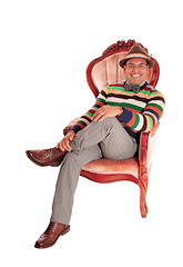 Image showing Smiling middle age man in armchair.