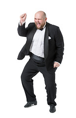 Image showing Jolly Fat Man in Tuxedo and Bow tie Shows Emotions