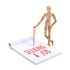 Image showing Wooden mannequin writing - Seeking a job