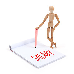 Image showing Wooden mannequin writing - Salary