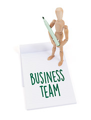 Image showing Wooden mannequin writing - Business team