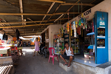 Image showing Indonesian man in front of his store in Manado shantytown