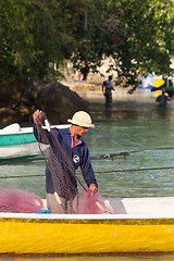 Image showing hindu fisherman men preparing net for fishing