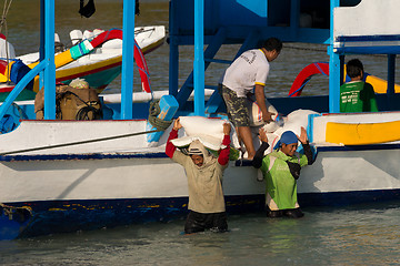 Image showing Men transports cargo from ship