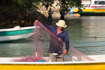 Image showing hindu fisherman men preparing net for fishing