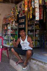 Image showing Indonesian man in front of his store in Manado shantytown
