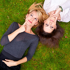 Image showing Two girls lying in the grass