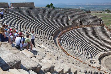 Image showing Guide and tourists in ancient amphitheater