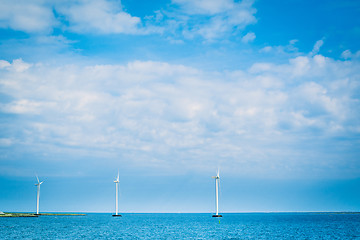 Image showing Windmills in the blue ocean