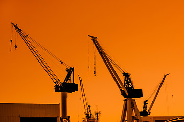 Image showing Crane silhouettes at a shipping harbor