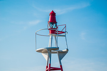 Image showing Small lighthouse on blue sky