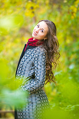 Image showing Portrait of a happy girl walking in the autumn forest