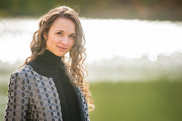 Image showing Portrait of a young girl on a background autumn coat River